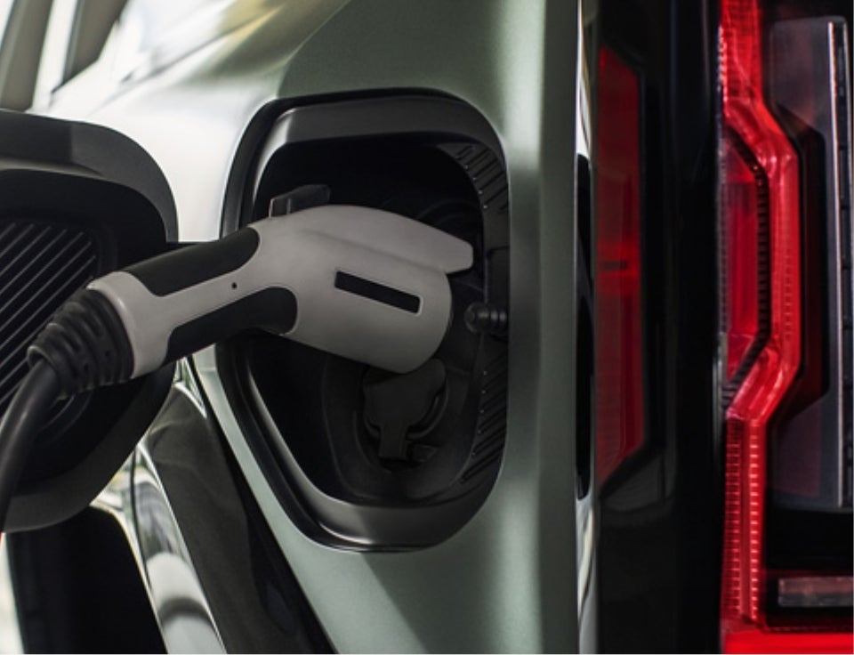 Close up of charging port with charger plugged in on a GMC Hummer EV SUV - Brown Automotive Center Buick GMC in DEL RIO TX