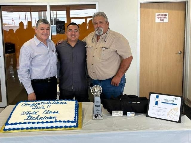 Celebrating Luis as World Class Technician with cake and awards