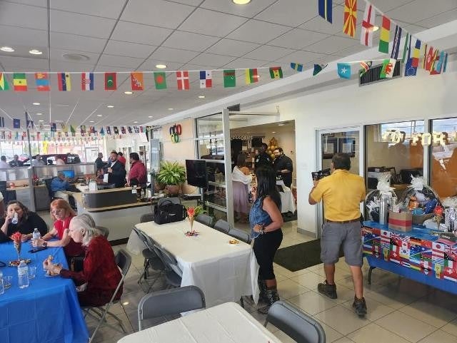 International-themed celebration inside showroom with food and decorations