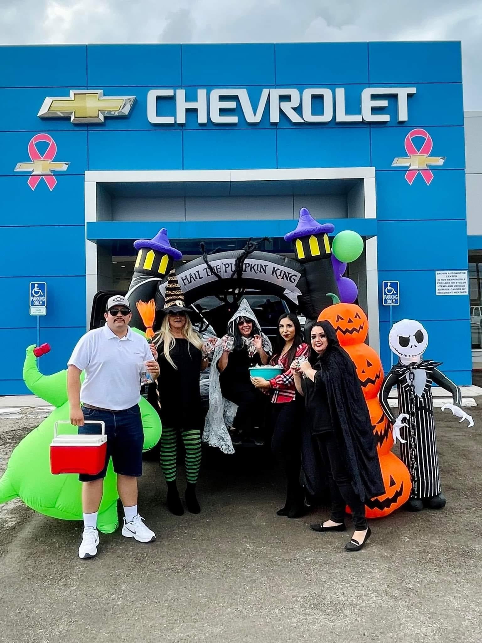 Chevrolet staff in Halloween costumes posing with spooky decorations