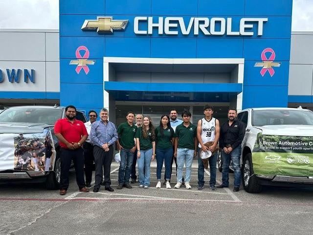 Heritage Academy group posing outside Chevrolet showroom